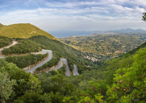 The winding road up to the village Sokraki on the island of Corfu. Corfu city at the horizon.