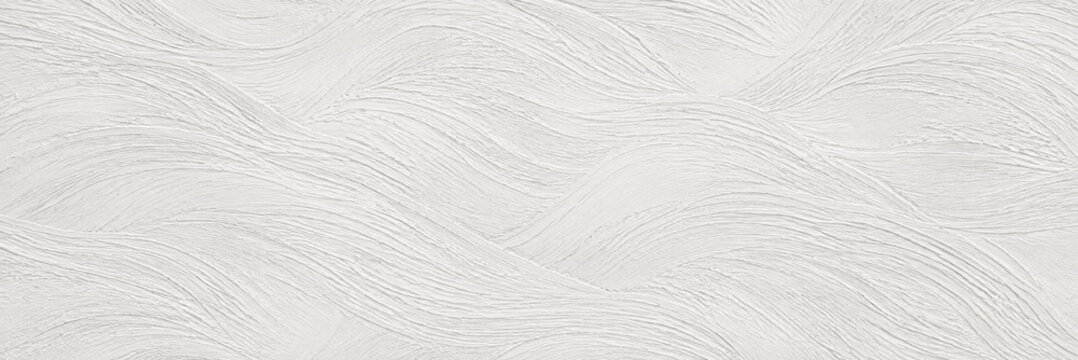 Abstract white plaster surface texture with subtle roughness and natural light