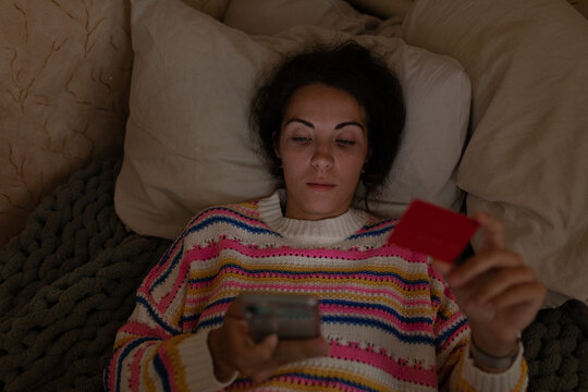 The girl enters credit card data into her phone