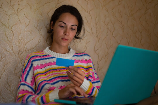 A young woman is making a purchase online.