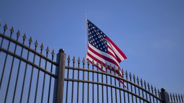American flag on metal security fence, U.S. government building