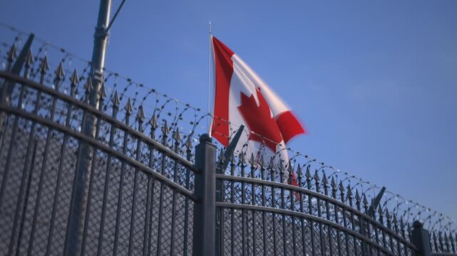 Canadian flag behind gates and barbed wire fence, consulate or penitentiary