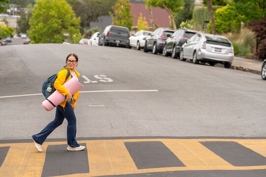 woman walking across crosswalk fitness gear