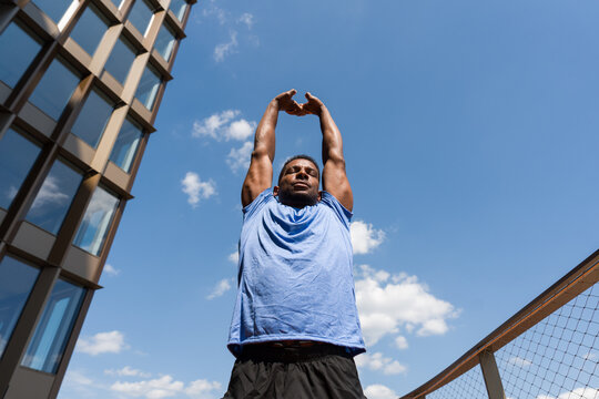 Athlete Stretching In Modern Architecture Background