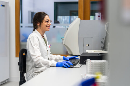 Scientist Working in a Lab With Computer and Equipment
