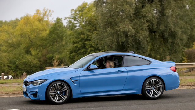 Milton Keynes; UK - Sept. 13th 2026:  2019 blue BMW M4 car driving on a British road