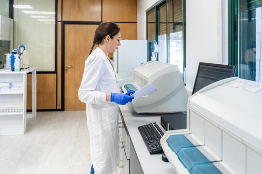 Scientist Working in Laboratory With Equipment and Computer