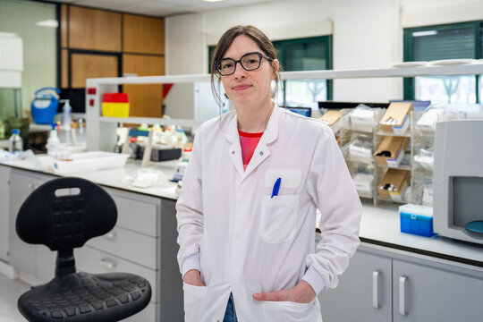 Scientist Works in a Laboratory Setting With Equipment and Samples