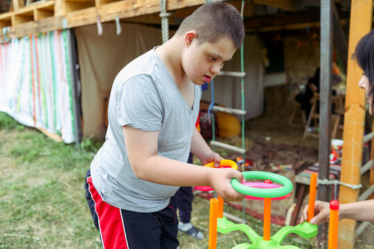 Outdoor activity with a child with Down syndrome at a camp