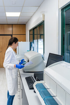 Scientist Working With Lab Equipment in a Clean Room Setting