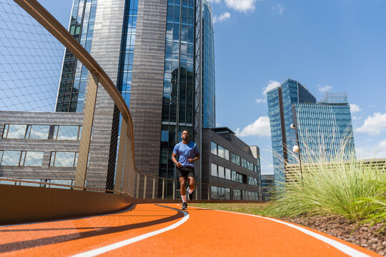 Man Running In High-Rise Architecture Background
