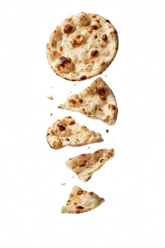 Indian naan bread falling with broken slices.