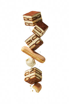Tiramisu cake slices floating in the air.