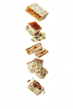 Nougat candy pieces with nuts and caramel.
