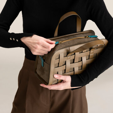 Hands Opening Leather Bag With Zipper