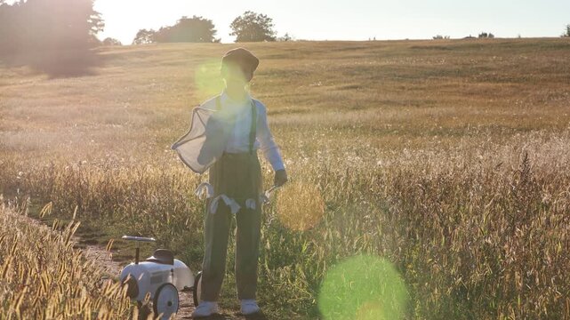 Sweet preteen child, boy, playing in a field on sunset with kite and old vingate car, walking with grandmother in the countryside