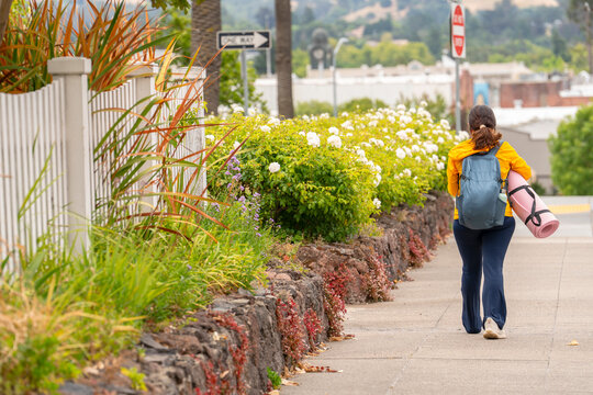 walking in neighborhood with sports gear