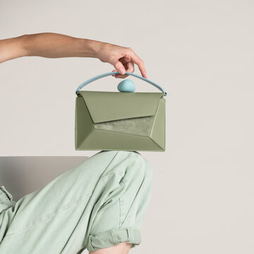 Green Handbag Held By Hand