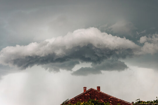 Storm Clouds Over Old Roof