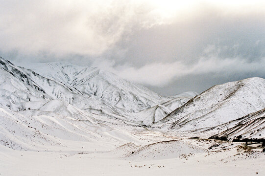 Majestic Snowy Mountains Under Dramatic Clouds