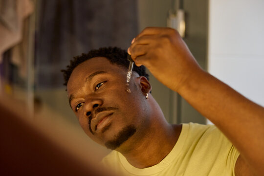 Man putting lotion on his face