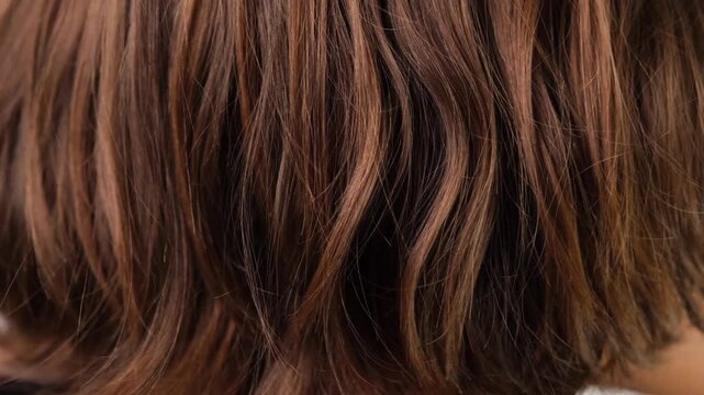 Close-up of long blonde and brown hair being gently touched and separated by fingers, showing hair texture, strands, scalp care and healthy hair.