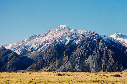 Film photo of a majestic Snowy Mountain under Clear Blue Sky