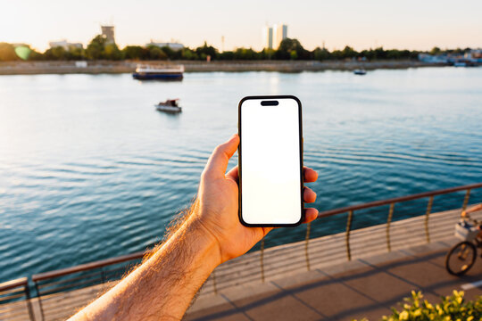 White Screen Phone at a Riverside Promenade