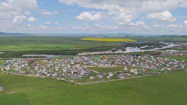 High-Angle Aerial Panoramic View of Tangke Town in Zoige, Aba, Sichuan: Plateau Grassland, Yellow River Basin, Rapeseed Fields, Blue Sky and Horizon Background