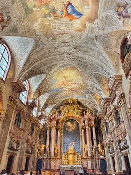 The interior of Benedictine church with fresco on the ceiling in the old town of Gyor, Hungary