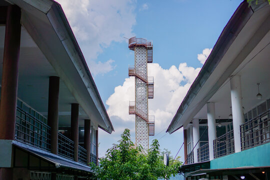 lighthouse between the building at sunny day. Old lifeguard structure, lookout tower on Weh island Sabang, Aceh.