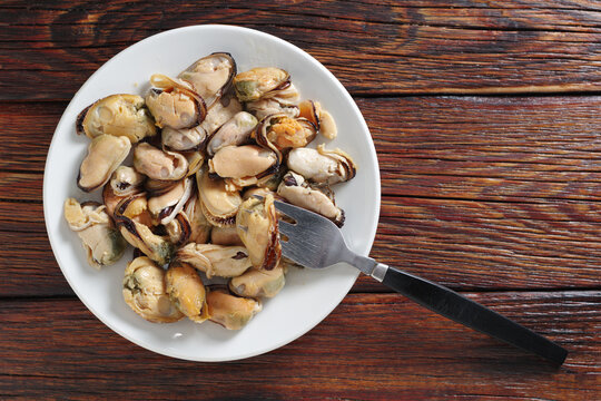 Delicious mussels on white plate