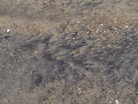 Natural black mineral sand texture on the shore in Langkawi Island, Malaysia.
