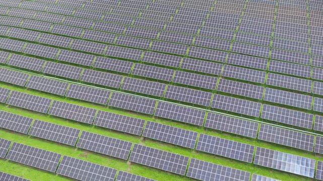 Top-Down Aerial Close-Up View of Solar PV Panel Array on Zoige Grassland: Renewable Clean Energy, Agrivoltaics, Green Field and Sunlight Background