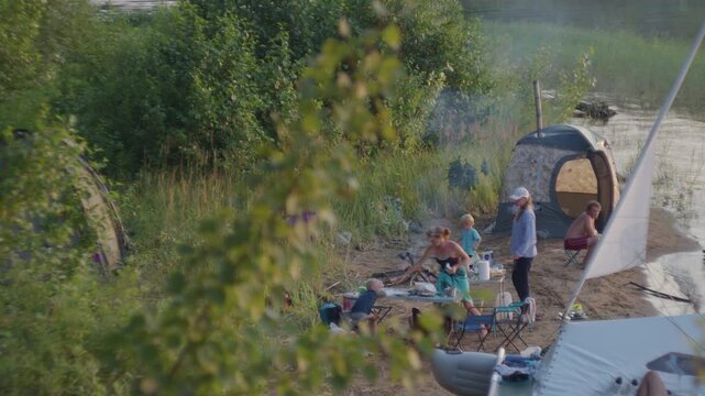 Family camping on the lake with kids