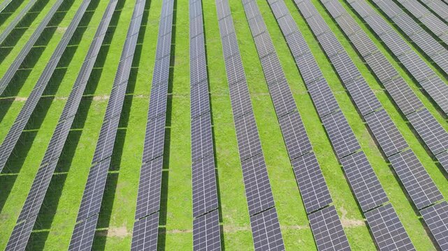 Top-Down Aerial Close-Up View of Solar PV Panel Array on Zoige Grassland: Renewable Clean Energy, Agrivoltaics, Green Field and Sunlight Background