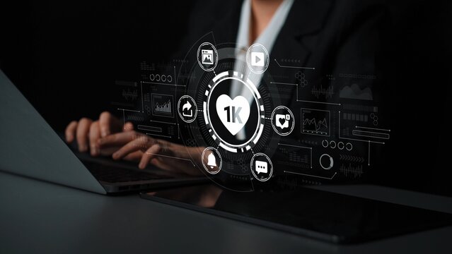 Business professional using laptop with data analysis icons and social media elements representing engagement metrics and digital communication trends. Entropy.
