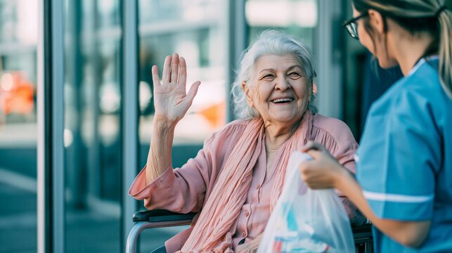 Happy Senior Patient in Wheelchair Waving Goodbye to Nurse Upon Hospital Discharge