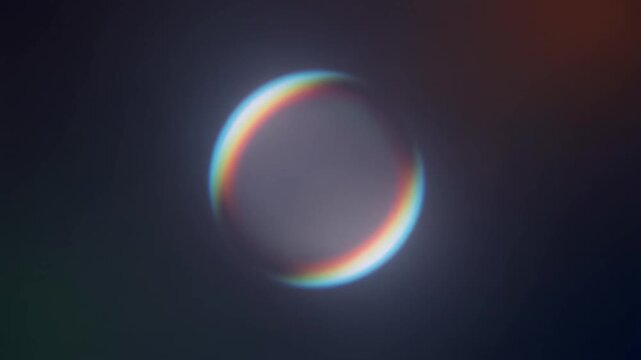 Abstract colorful glowing sphere with chromatic aberration and lens flare effect on a dark background