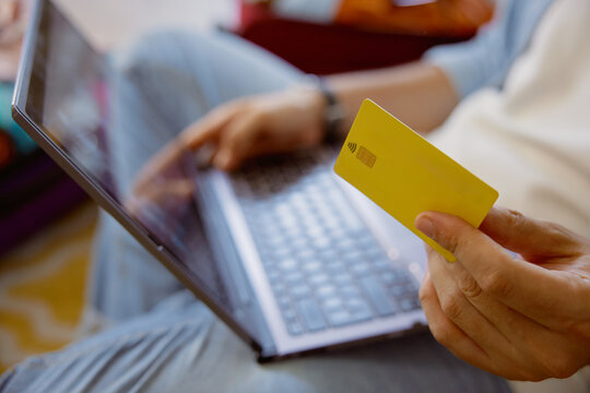 Closeup shot of male hand holding plastic credit card for travel payment online