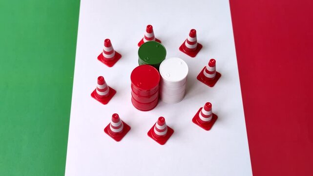 Metal barrels of oil, gas, or chemicals bearing on the flag of Italy and a ban sign, embargo