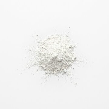 White powder scattered across a clean white surface with generous copy space in a minimalist overhead flat lay composition