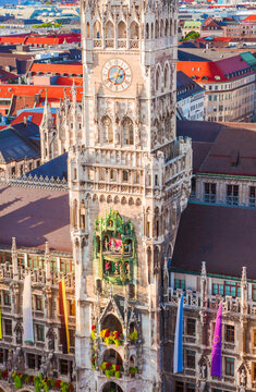 Munich New Town Hall and Marienplatz Aerial View at sunset. Ornate Gothic architecture, distinctive clock tower, surrounding historic buildings, and vibrant city square. Germany