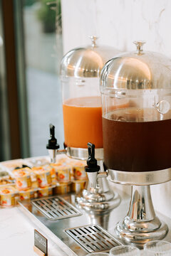 Hotel buffet station with fresh orange juice and cold brew coffee