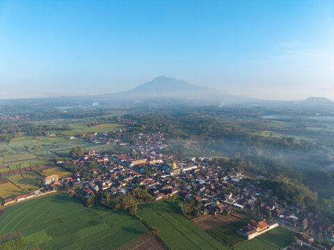 This stunning aerial view captures a tranquil village nestled in lush greenery at Ngajum, Malang