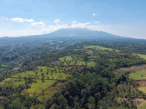 Stunning aerial view showcasing a vibrant green landscape with a majestic mountain backdrop at Ngajum, Malang