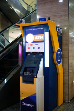 Melacca, Malaysia - &lrm;September 8, 2026 - ATM self-service banking machine located inside a shopping mall near an escalator.
