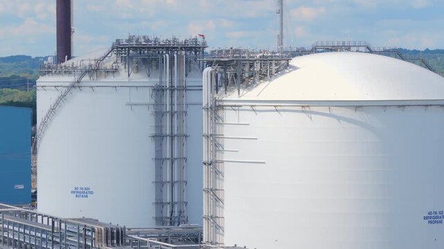 Drone view of massive industrial cryogenic storage tanks