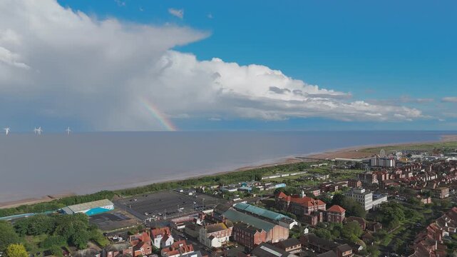 Rainbow arches over coastal town
