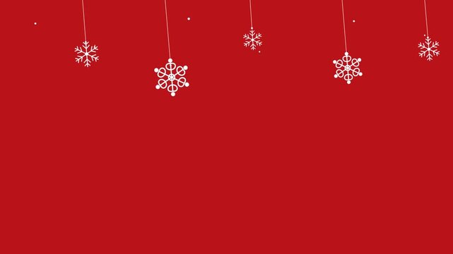 Festive Christmas background with white decorative snowflakes hanging from the top on a solid red backdrop for winter holiday celebrations